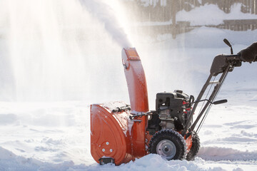 A portable snow blower powered by gasoline. Snow removal in winter.
