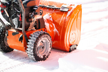A portable snow blower powered by gasoline. Snow removal in winter.