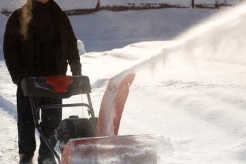 A portable snow blower powered by gasoline. Snow removal in winter.