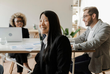 diverse group of business people in office focus on asian woman