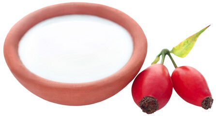 Rose hips with fresh milk in a pottery