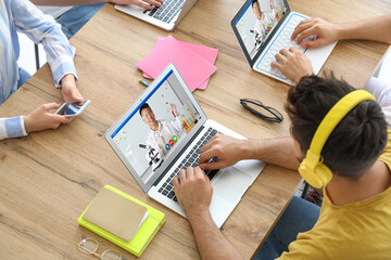 Group of friends studying online at table