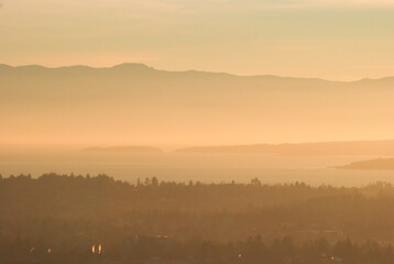 Hazy or smoky sunset over the south of Vancouver Island with the Olympic Peninsula in the distance.