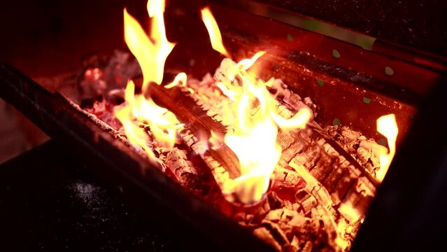 The wood burns in the brazier.