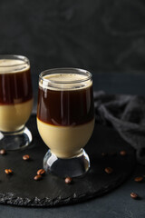 Glasses of tasty Cafe Bombon on dark background, closeup