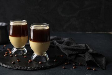 Glasses of tasty Cafe Bombon on dark background
