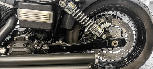 Chrome rear wheel and exhaust on a chopper motorbike. bike in garage Wheel, brake disc, exhaust...