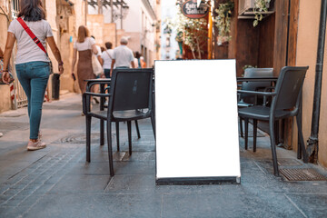 Close up of empty white poster near cafe or restaurant. Mockup background. 