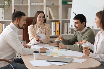 Group of people working on business plan in office