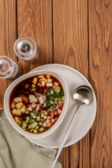 Sliced vegetables and meat for okroshka are laid out in a plate