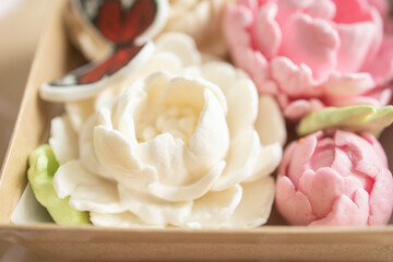 sweet dessert, gift, marshmallow peony flowers in plastic packaging, on a light background. Sugar addiction, consumption, handmade dessert. Low calorie marshmallows, carbs