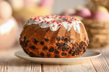 Plate with tasty Easter cake on white wooden table, closeup