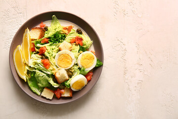 Plate of delicious salad with boiled eggs and salmon on white grunge background