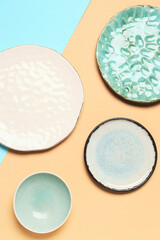 Composition with clean ceramic plates on blue and beige background