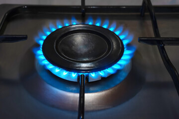 Flame of propane gas burning on kitchen gas stove.