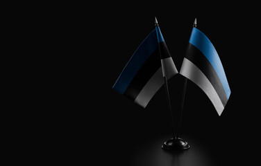 Small national flags of the Estonia on a black background