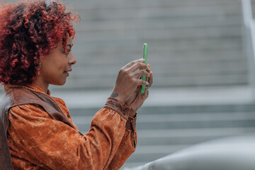 profile girl on the street with mobile phone and afro hair