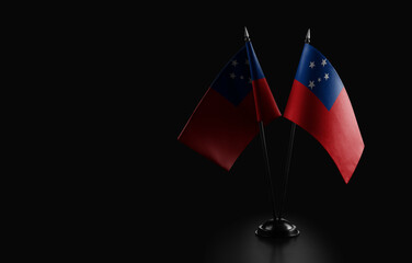 Small national flags of the Samoa on a black background