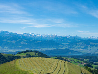 Zurich, Switzerland - June 12th 2022: Amazing view from Alp Scheidegg over hills and the lake towards the mountains