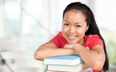 Happy young beautiful woman student posing