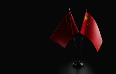 Small national flags of the China on a black background