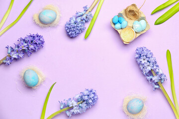 Frame made of beautiful hyacinth flowers and Easter eggs on lilac background