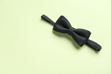 Black bow tie on color background
