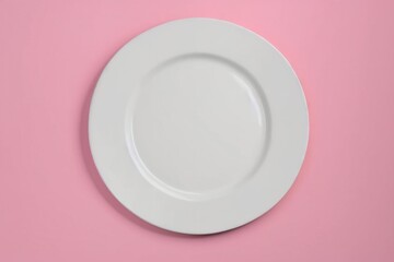 white plate on a pink background