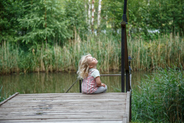 Little girl lake and warm summer evening