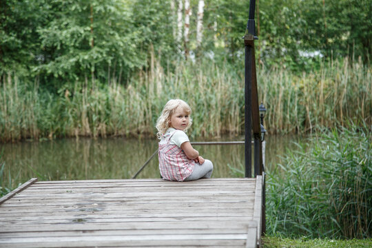 Little girl lake and warm summer evening