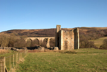 Edlingham Castle and old arched bridge in winters sunshine