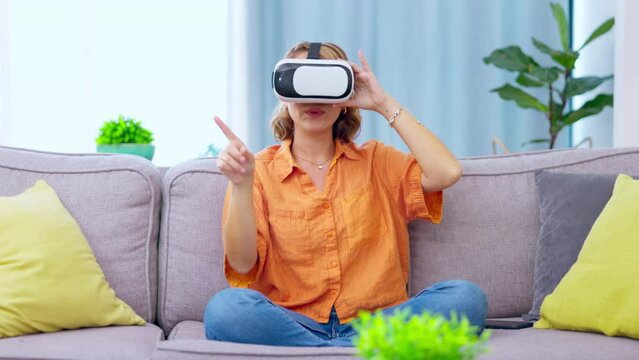 Vr, 3d metaverse and woman on sofa, gaming and click on ui with digital technology. Ai, virtual reality and female press with future headset for fantasy simulation, esports or playing games at home.