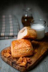 Bakery shop products - various kinds of baguette, bagel, donut, croissant, rolls, bread, puff pastry, powdered sugar delicious pies. Neutral background. Food from bakeries.