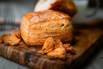 Bakery shop products - various kinds of baguette, bagel, donut, croissant, rolls, bread, puff pastry, powdered sugar delicious pies. Neutral background. Food from bakeries.