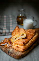 Bakery shop products - various kinds of baguette, bagel, donut, croissant, rolls, bread, puff pastry, powdered sugar delicious pies. Neutral background. Food from bakeries.