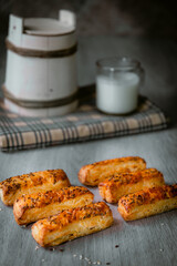 Bakery shop products - various kinds of baguette, bagel, donut, croissant, rolls, bread, puff pastry, powdered sugar delicious pies. Neutral background. Food from bakeries.