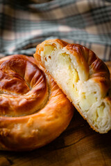 Bakery shop products - various kinds of baguette, bagel, donut, croissant, rolls, bread, puff pastry, powdered sugar delicious pies. Neutral background. Food from bakeries.