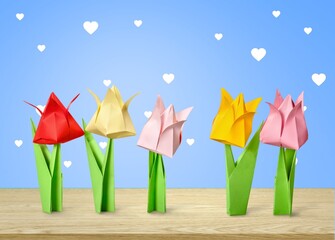 Origami colored tulip flowers on the desk