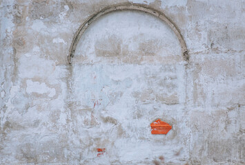 Background, texture of a gray stone wall with an arch immured with cement. Closeup photo, vintage, copy space.