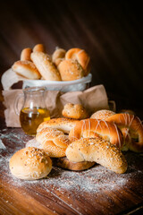 Bakery shop products - various kinds of baguette, bagel, donut, croissant, rolls, bread, puff pastry, powdered sugar delicious pies. Neutral background. Food from bakeries.
