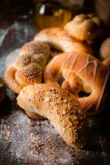 Bakery shop products - various kinds of baguette, bagel, donut, croissant, rolls, bread, puff pastry, powdered sugar delicious pies. Neutral background. Food from bakeries.