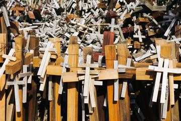 Wooden cross symbol of christianity texture. Holy place catholic religion. Hanging rosary background. Pilgrimage destination. Cementary landscape. Graveyard symbol. Hope background.