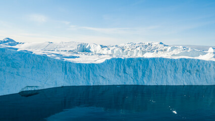 Fototapeta Giant iceberg. Global warming and climate change concept. Icebergs in Disko Bay on greenland in Ilulissat icefjord from melting glacier Sermeq Kujalleq Glacier, Jakobhavns Glacier. Aerial drone image obraz