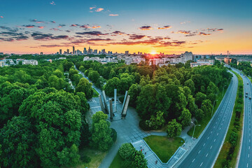 Sunset over green park and Warsaw city center, aerial landscape - obrazy, fototapety, plakaty