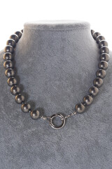 author stylish  beautiful  steel color pearls necklaces with heart pendant demonstrated on maneken. fashion and jewelry concept