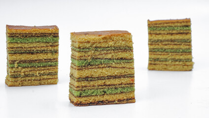 Slices of Indonesian Lapis Cake against white background. selective focus