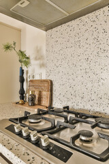 a kitchen with granite counter tops and stoves in the fore - image was taken from an article...