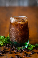 iced sparkling americano with mint syrup on wooden table