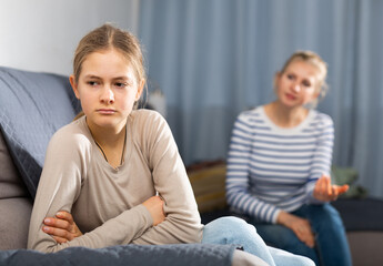 Mother soothes teen daughter after an quarrel at home