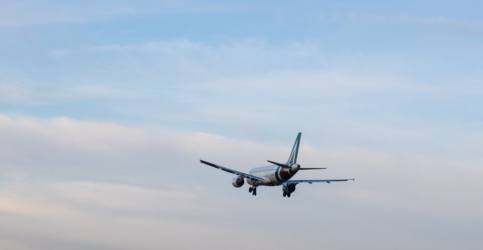 LINATE AIRPORT, ITALY - CIRCA JANUARY 2023: commercial flights landing at Milan's city airport in the late afternoon